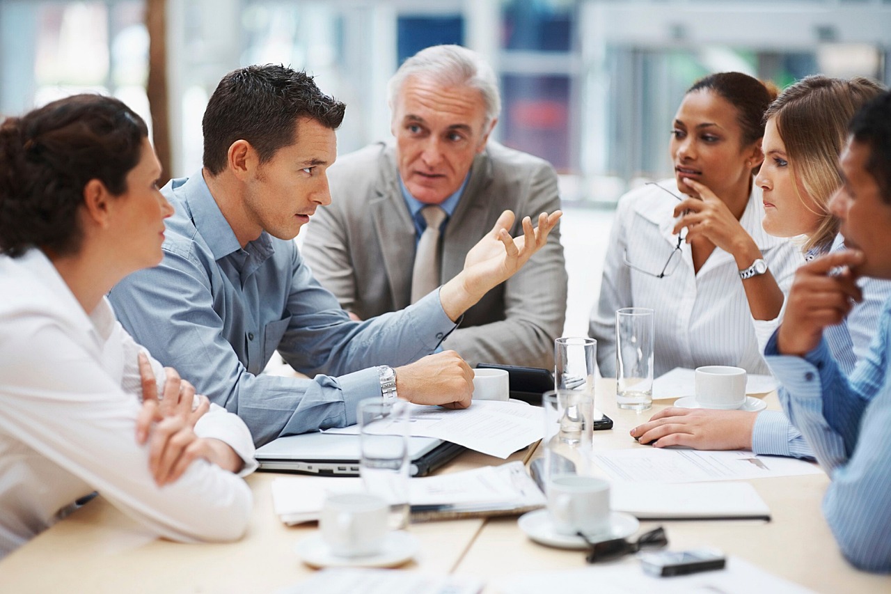 Accounting firm team meeting with small business clients to discuss financial strategy in a modern office