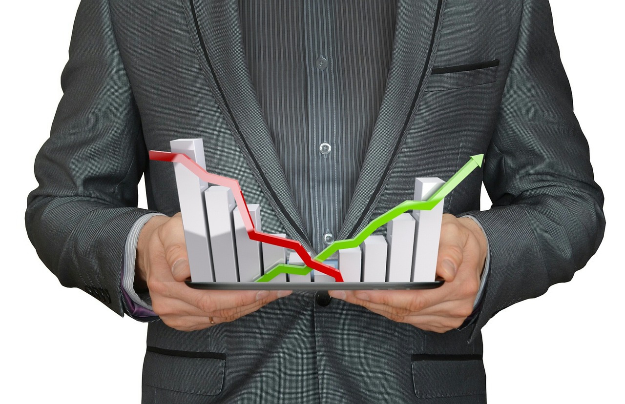 Business professional reviewing a financial growth chart on a tablet during an accounting review meeting