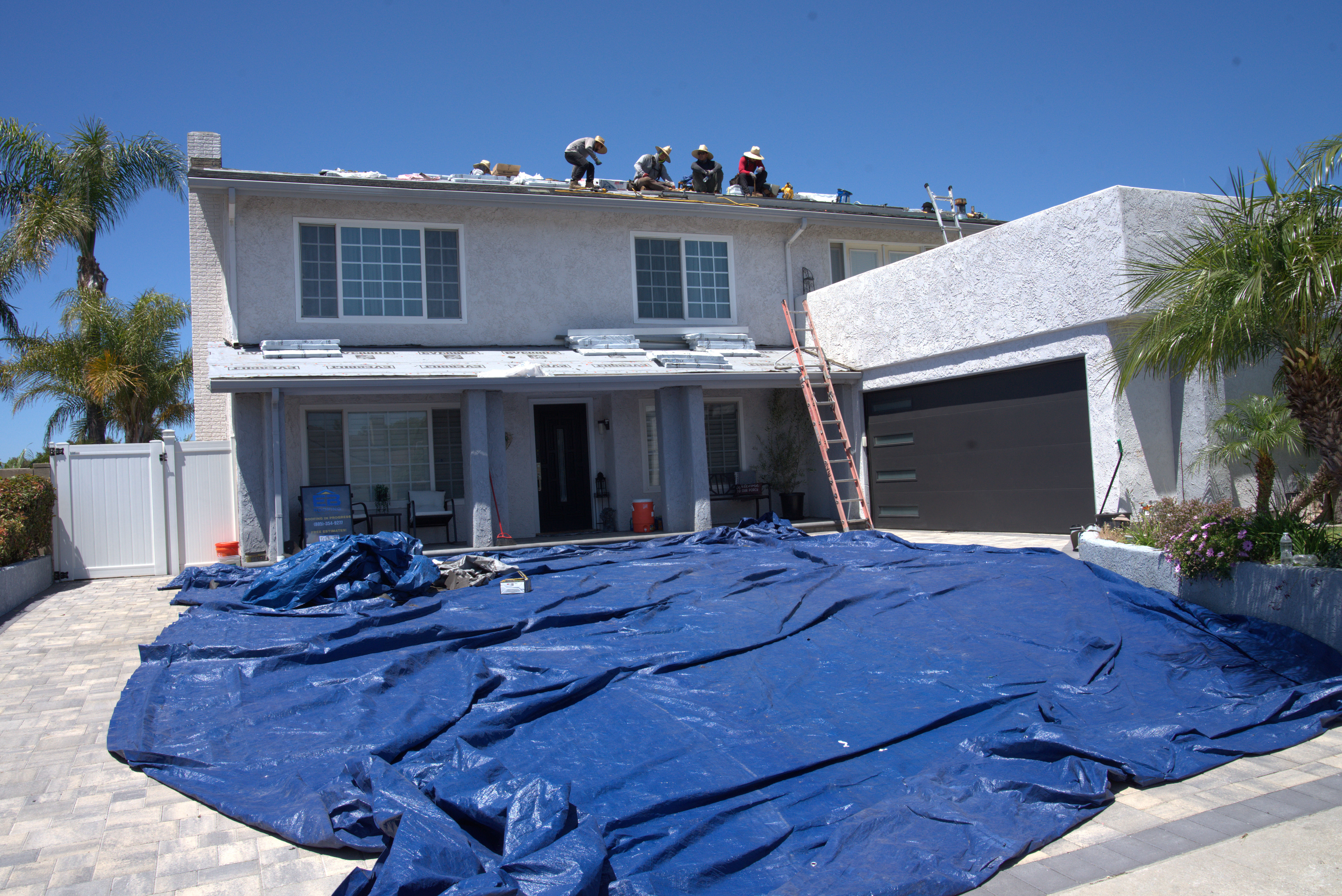 Sovereign Roofing crew preparing a detailed quote on site