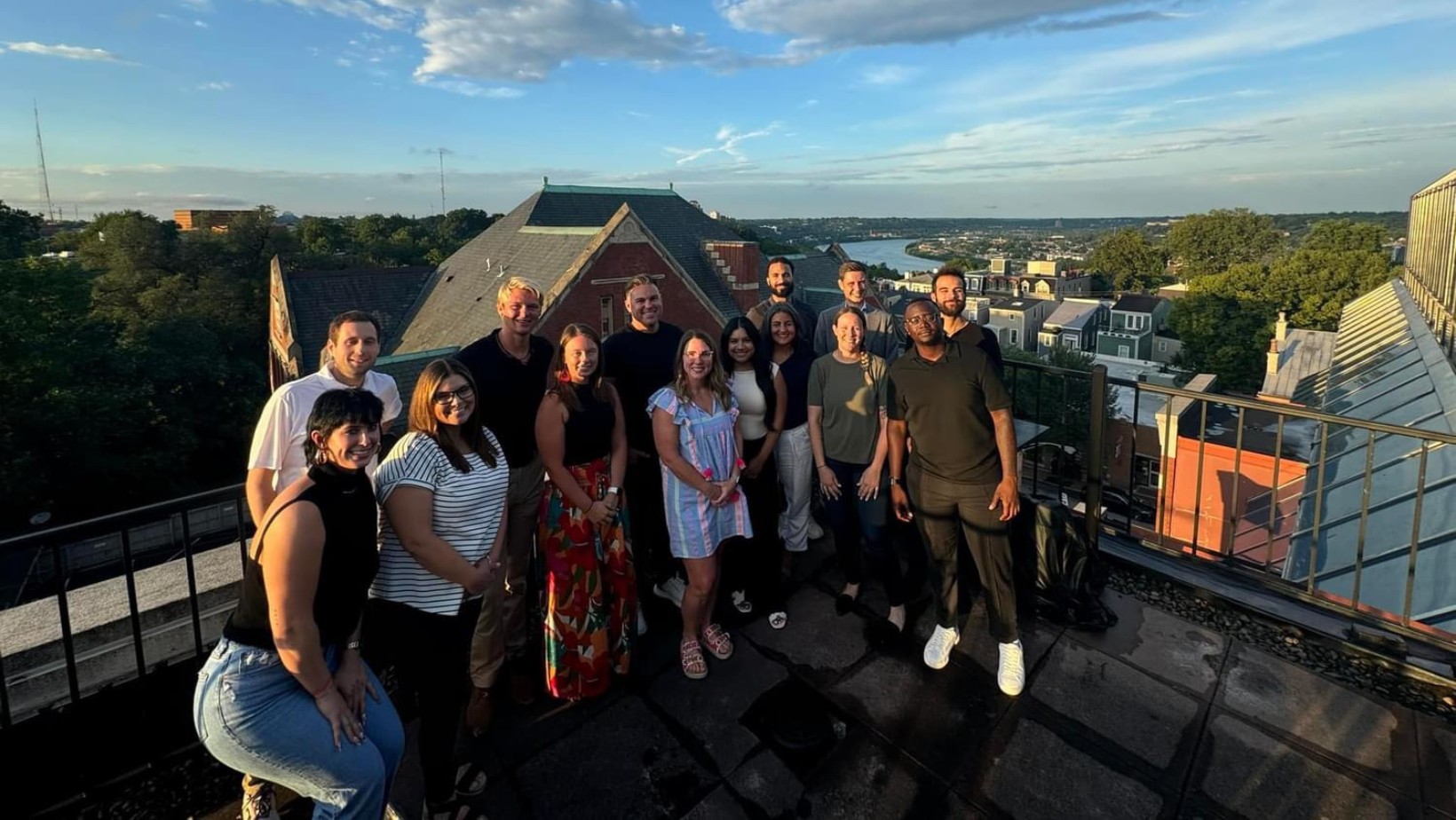 Agents from the organization together at a rooftop event