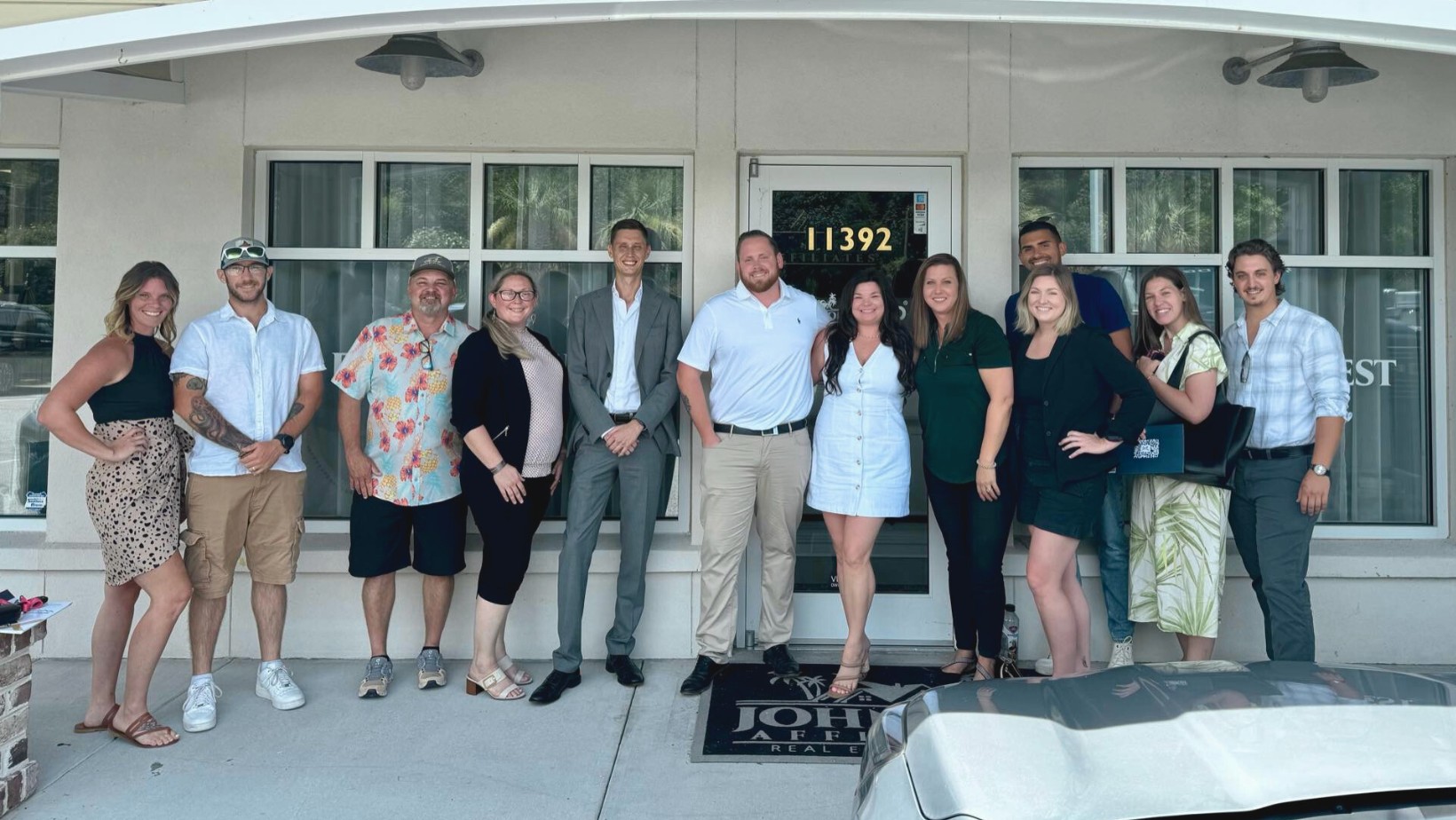 A partner team together outside their eXp Realty office