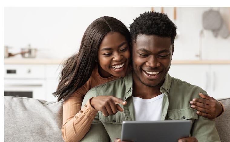 Couple reviewing their ORYGN earnings on a tablet