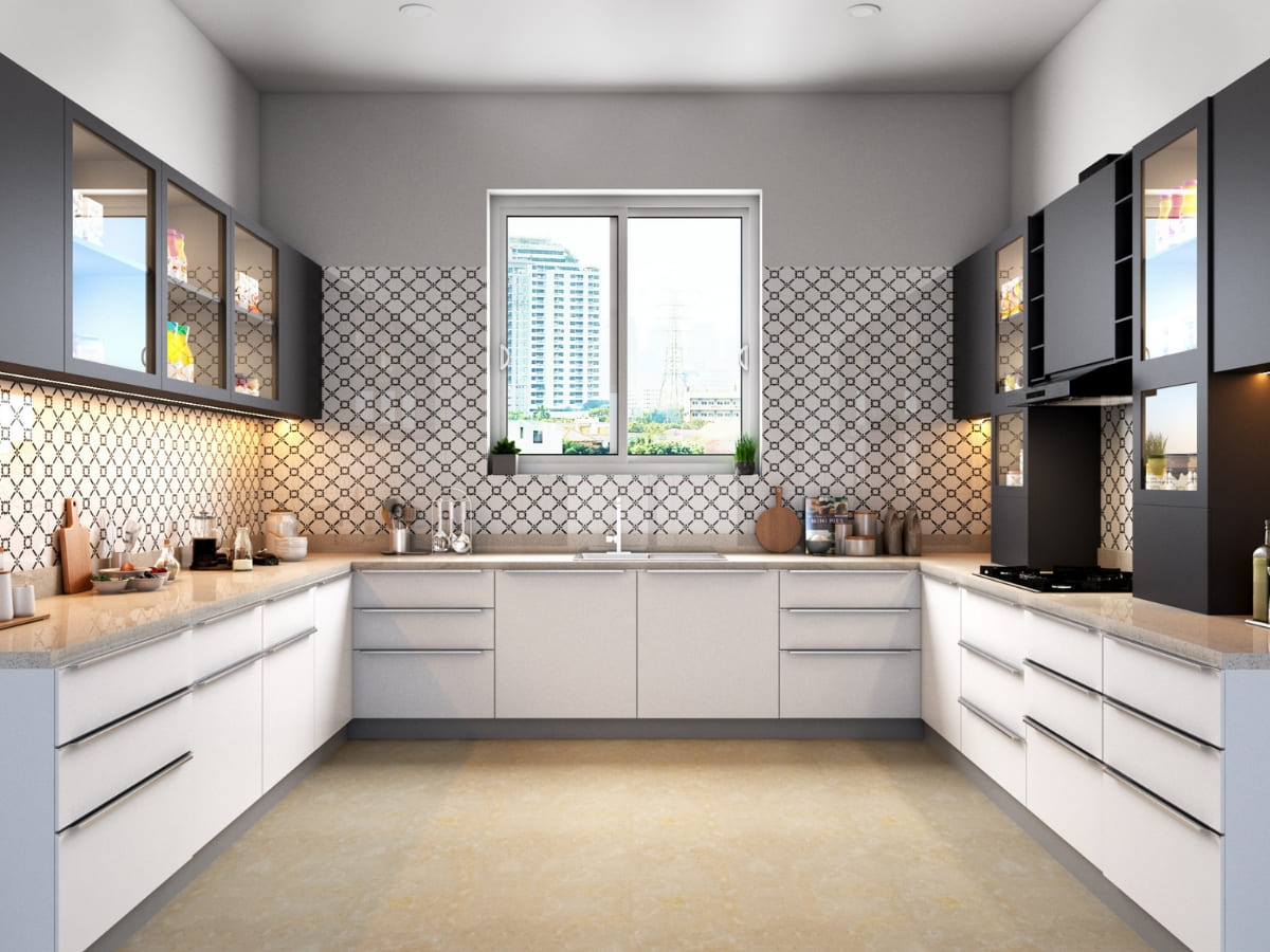 A sleek kitchen with a geometric tile backsplash, white and gray cabinets, and large windows providing ample natural light.