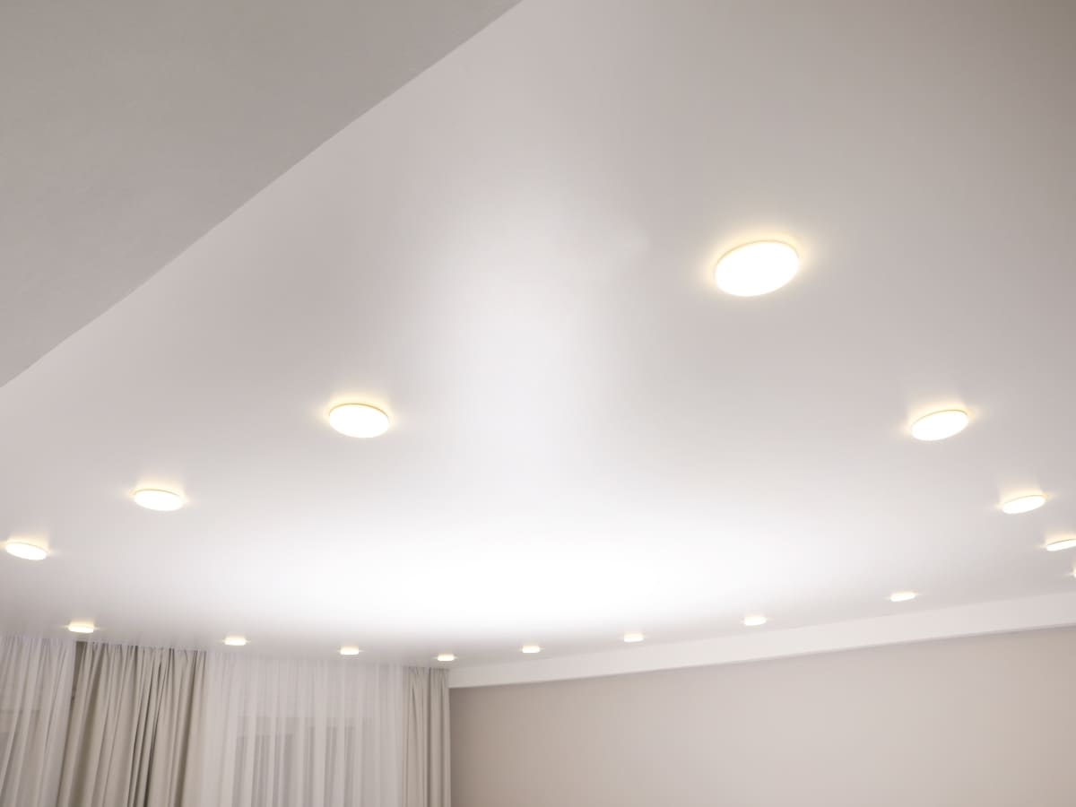 Ceiling with recessed lighting, providing uniform illumination in a modern, clean space designed for energy efficiency and aesthetics.