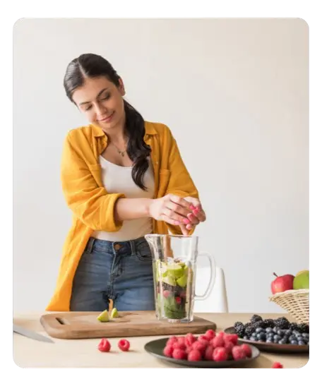 Femme préparant un smoothie détox aux fruits rouges pour une détoxification cellulaire naturelle