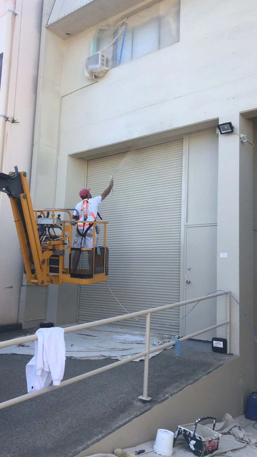 Spot Painting team member working at height on a commercial building exterior