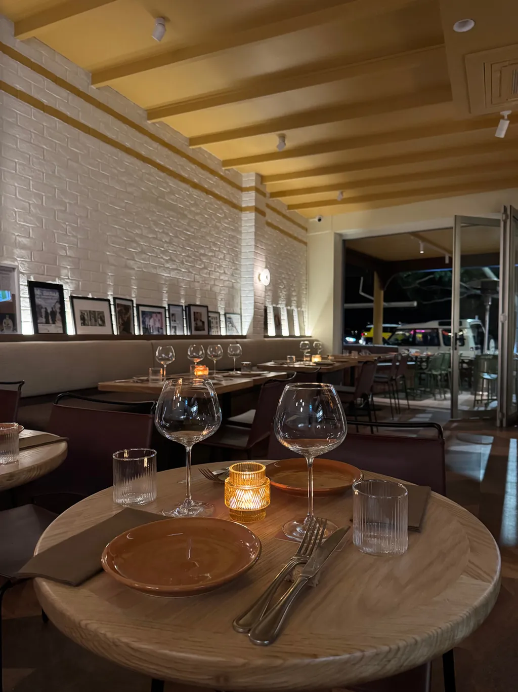 Restaurant interior painting — warm textured brick and ceiling beams