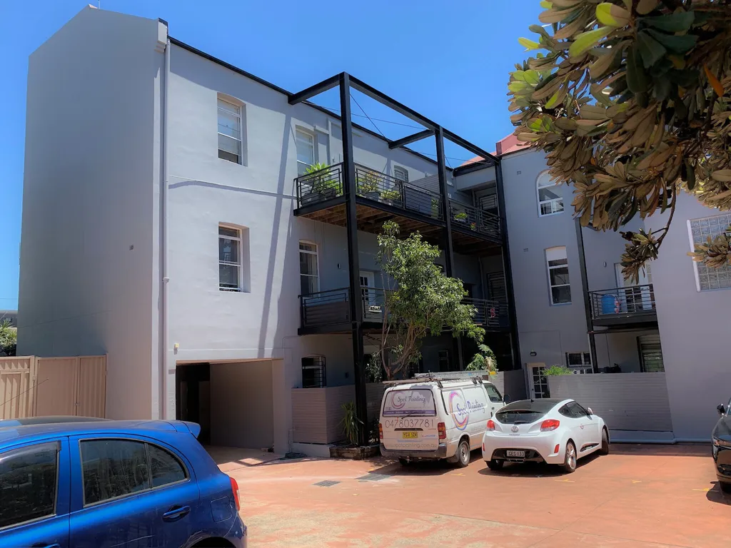 Commercial building exterior — full repaint before and after
