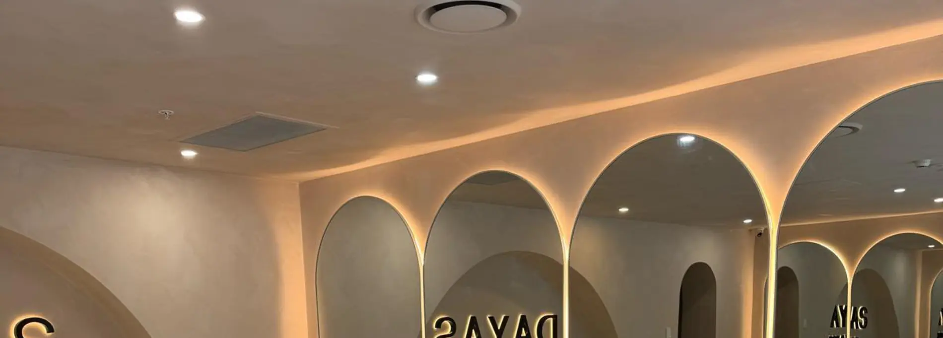 Pilates studio interior — arched wall detailing and lighting finished by Spot Painting