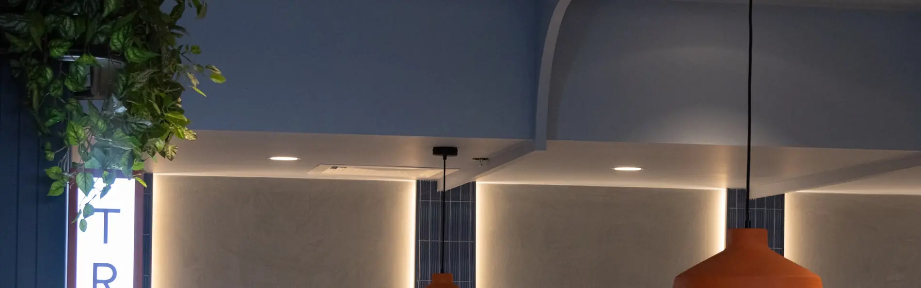 Retail interior — arched feature wall with warm backlighting by Spot Painting