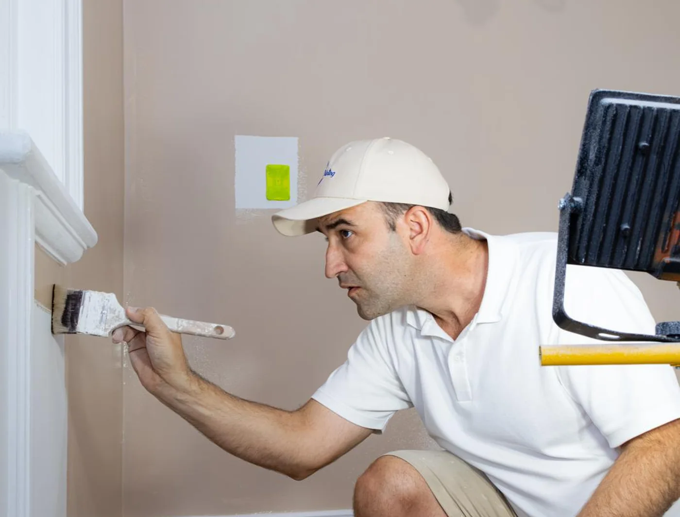 Spot Painting painter cutting in a wall edge with a brush