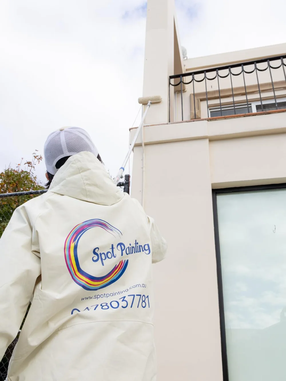 Spot Painting team member working on an exterior wall