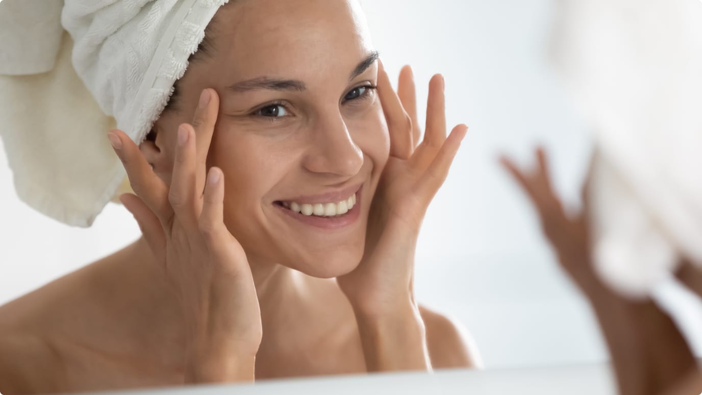 Woman touching face after microneedling