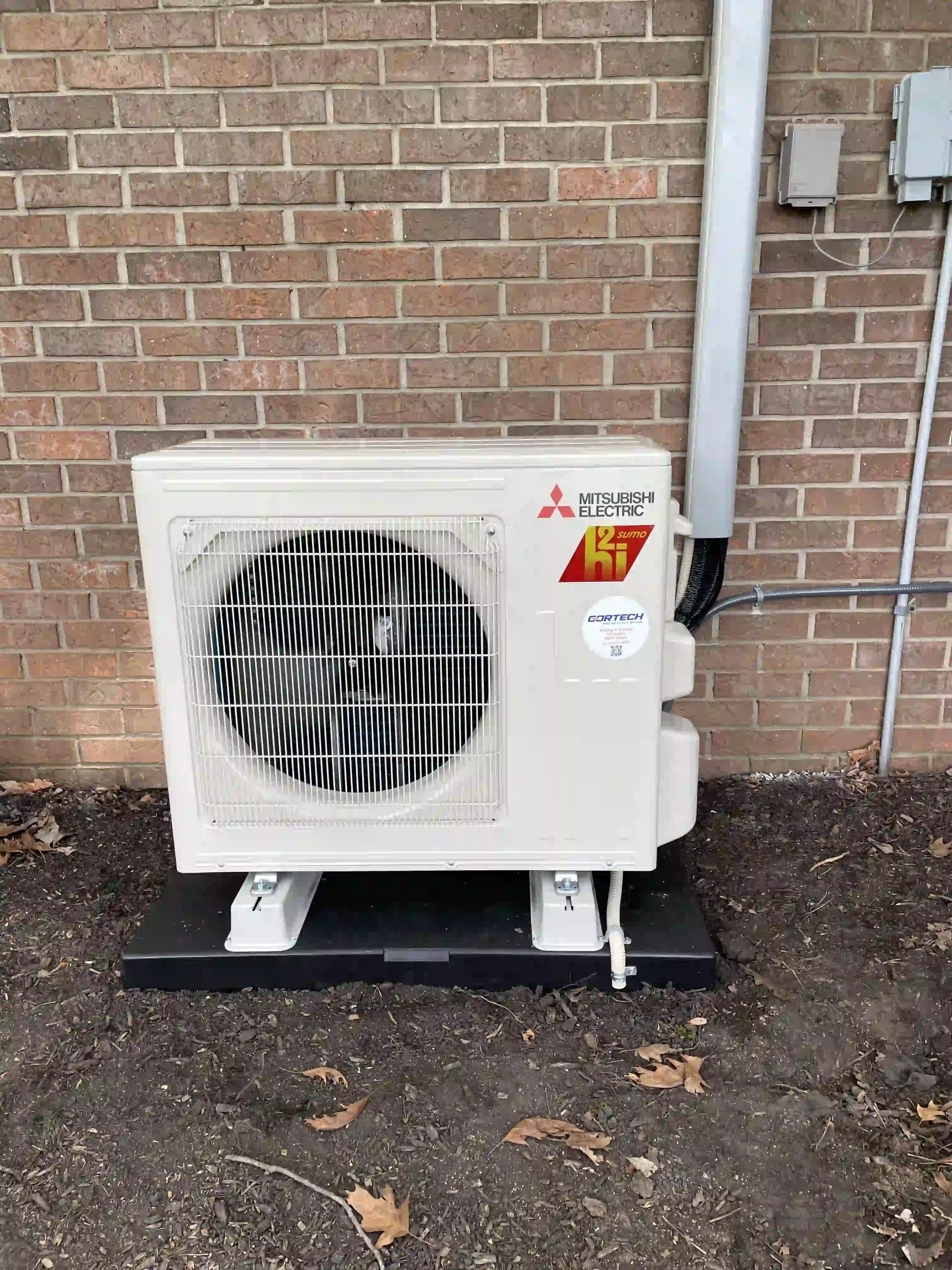 Ductless mini-split heat pump installed on a home