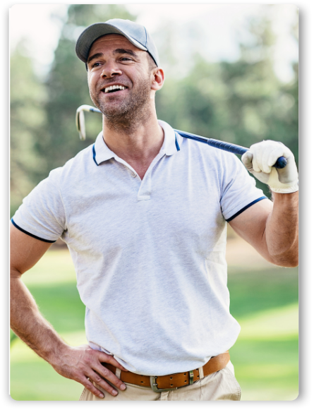 Man smiling and holding a golf club over his shoulder, showcasing confidence building and mental toughness in golf.