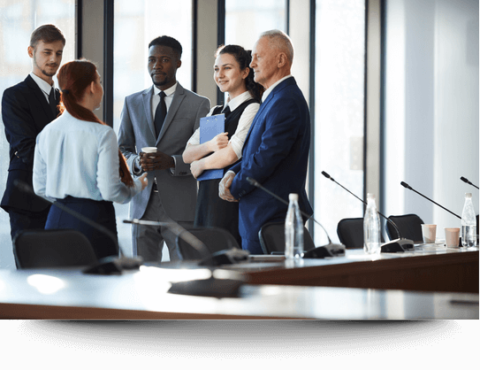 Corporate team members standing together, engaged in a discussion, showcasing the collaborative environment fostered by the Flame Technique training for immediate emotional support.