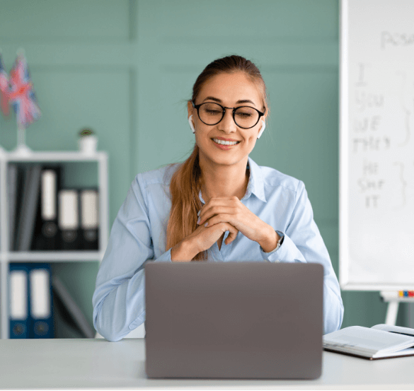 Smiling woman with headphones attending virtual Emotional Footprint® Coach Certification training on her laptop. Learn the Biko® Method through online coaching certification with live workshops, video lessons, printable tools, and career support for emotional wellness professionals.