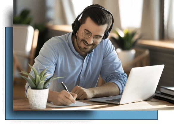 A happy man wearing a headset takes notes on paper while attending a 60-minute one-on-one Biko Method session virtually. This personalized emotional coaching session includes a live breakthrough experience, subconscious belief clearing, and an Emotional Footprint® analysis for deep emotional healing.