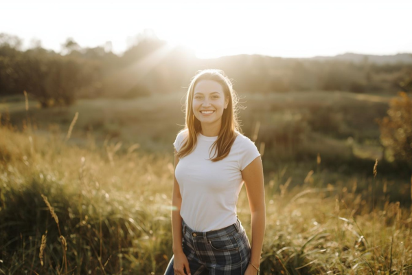 Person standing outdoors in a peaceful natural environment  Relaxed posture and confident expression