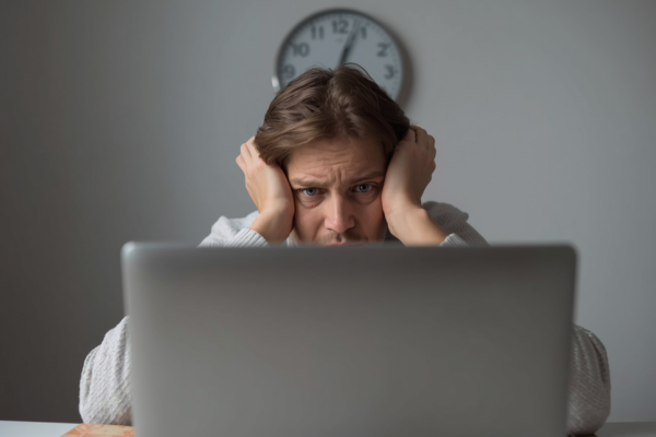 🖼 Image Idea: A person staring at an unfinished project (e.g., laptop or notebook), frozen and hesitant, while a clock in the background shows time passing.