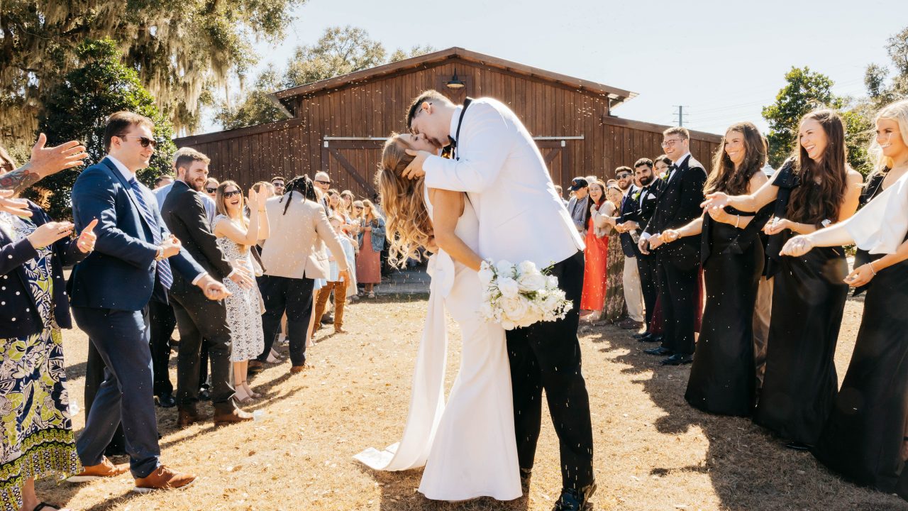 Guests holding sparklers as the couple makes their exit from the barn