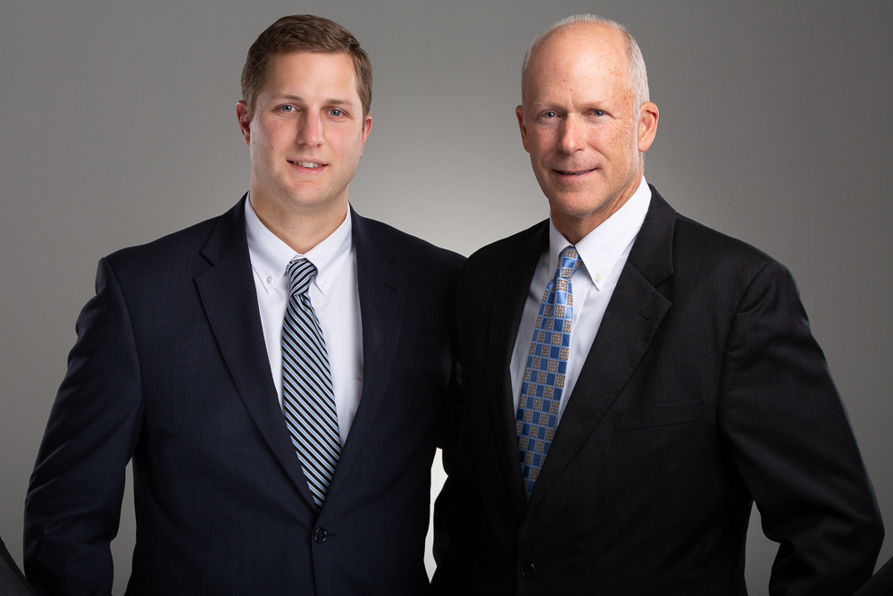 Image of a father and son in professional attire 