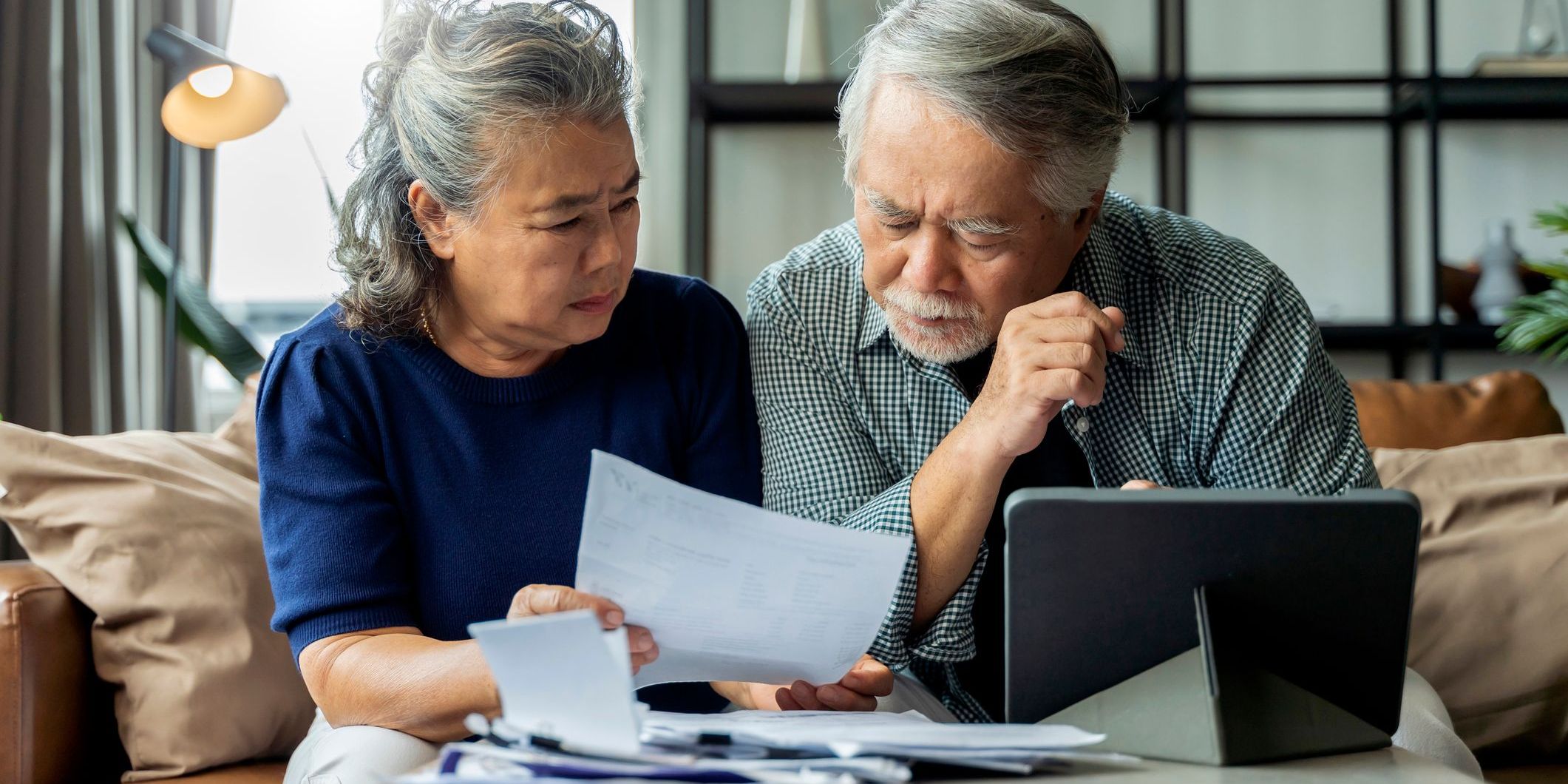 A retired couple going over benefit paperwork together