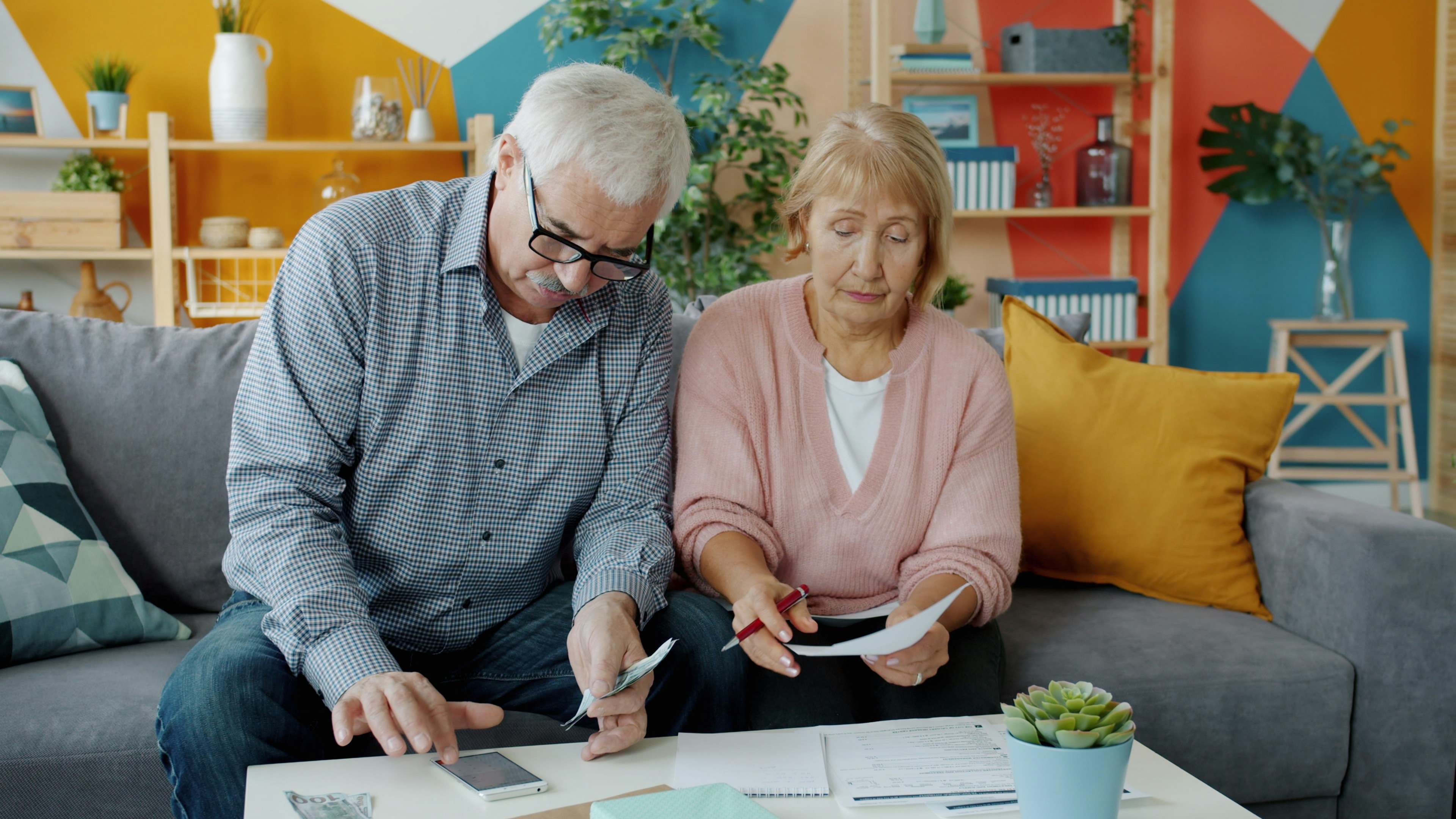 A retired couple reviewing their paperwork together