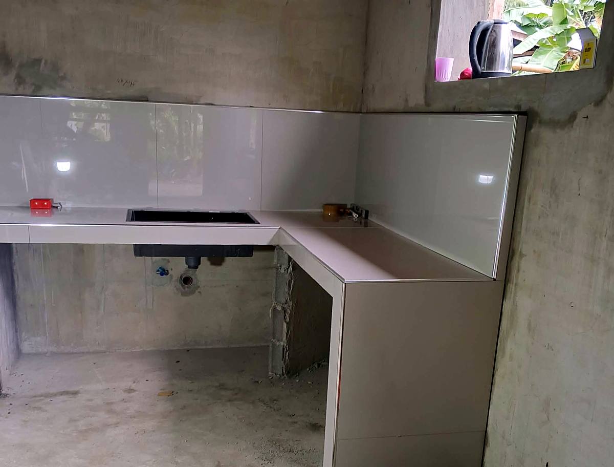 Tiled L-shaped kitchen counter with sink — Triple J Builders