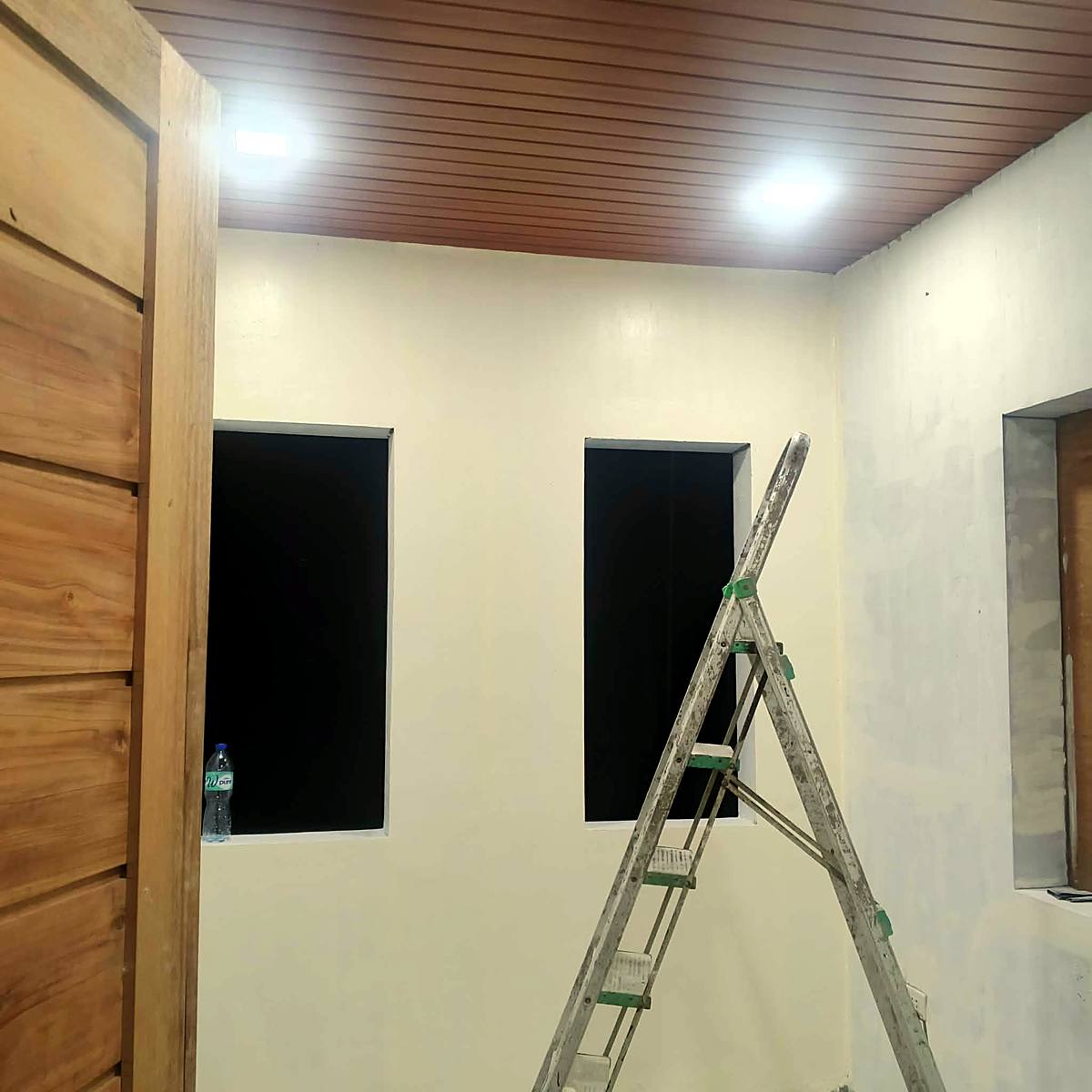 Finished room with wood-finish ceiling and recessed lights — Triple J Builders