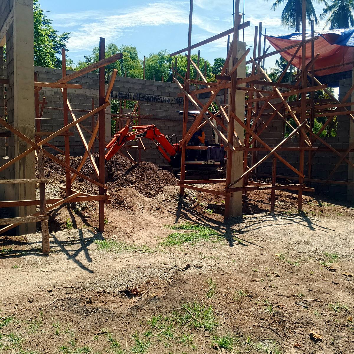 Site excavation inside a building under construction — Triple J Builders