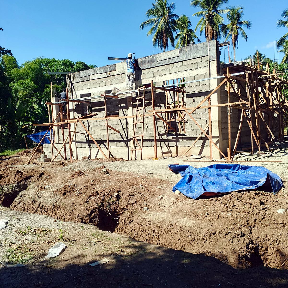 Concrete block house construction with scaffolding — Triple J Builders