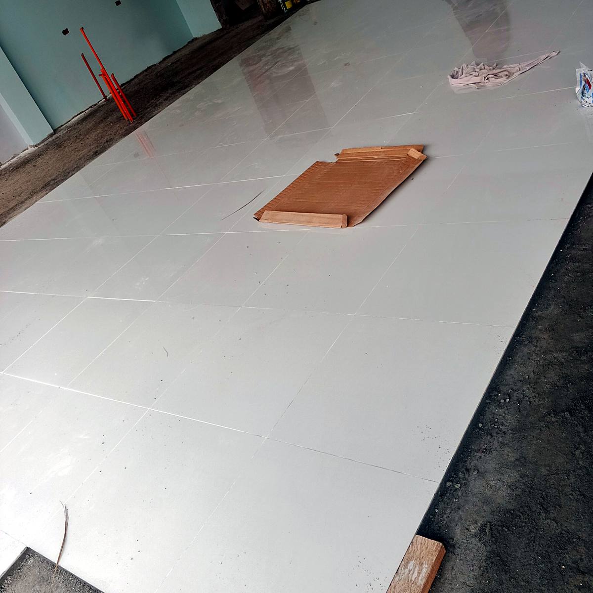 Newly installed white floor tiles — Triple J Builders