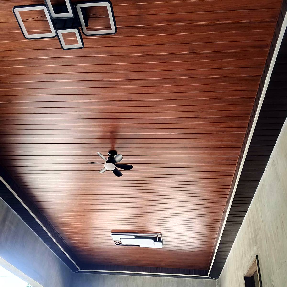 Wood-finish slat ceiling with modern LED lighting — Triple J Builders