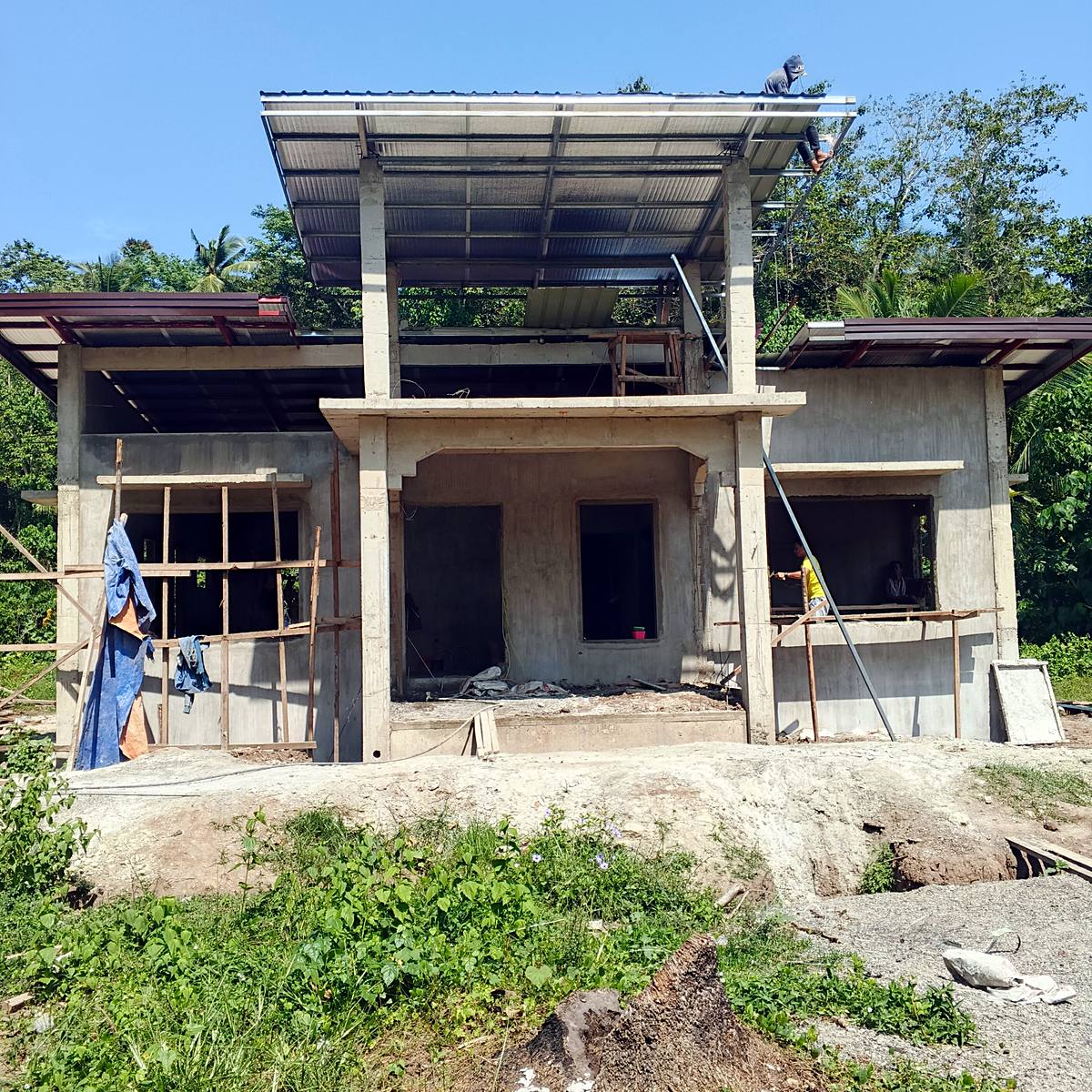 Two-storey house under construction with new roofing — Triple J Builders