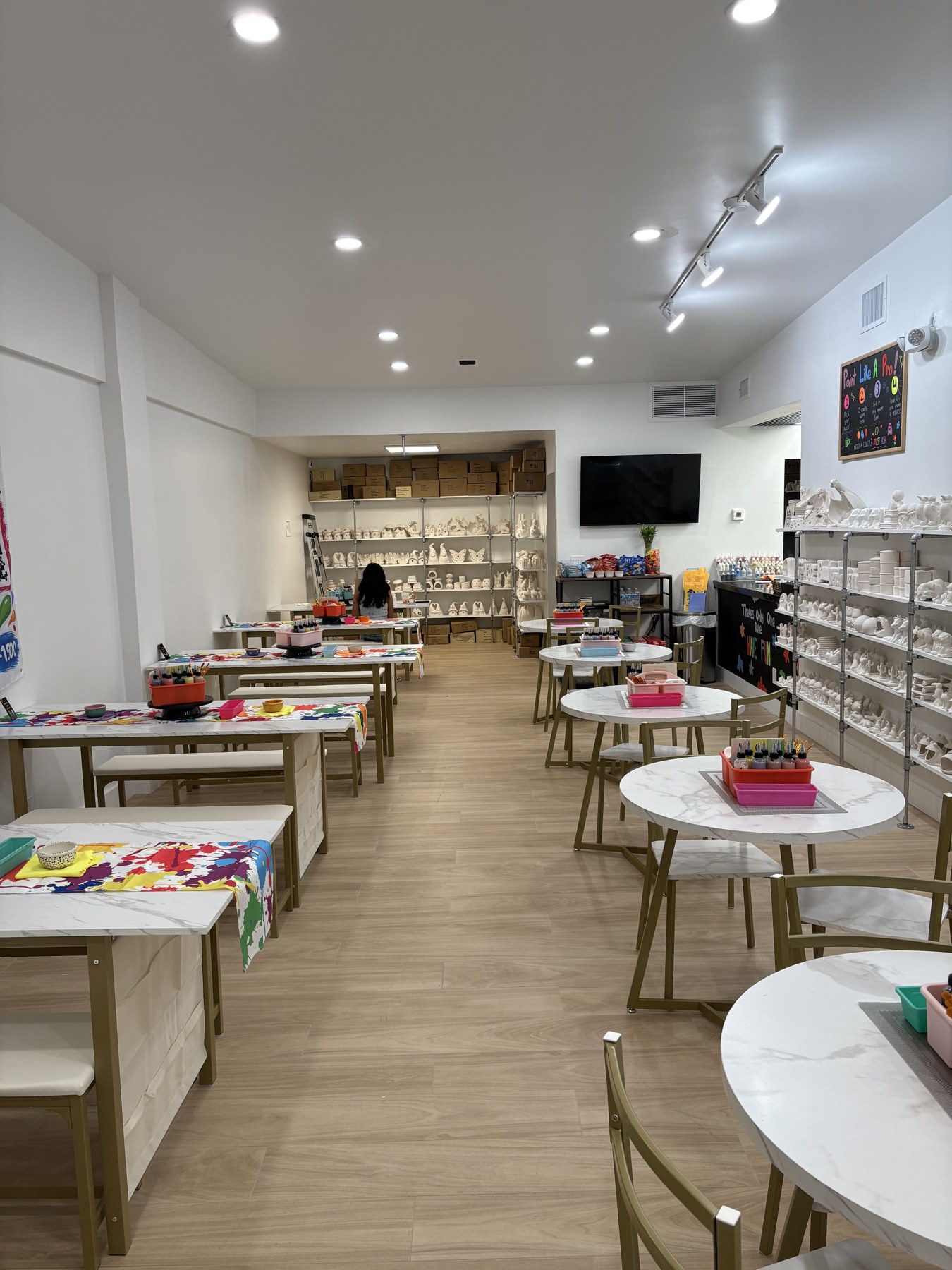 Bright new Delray studio with tables for painting and pottery displays