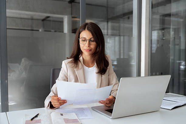 HR practitioner reviewing workplace documentation at a desk