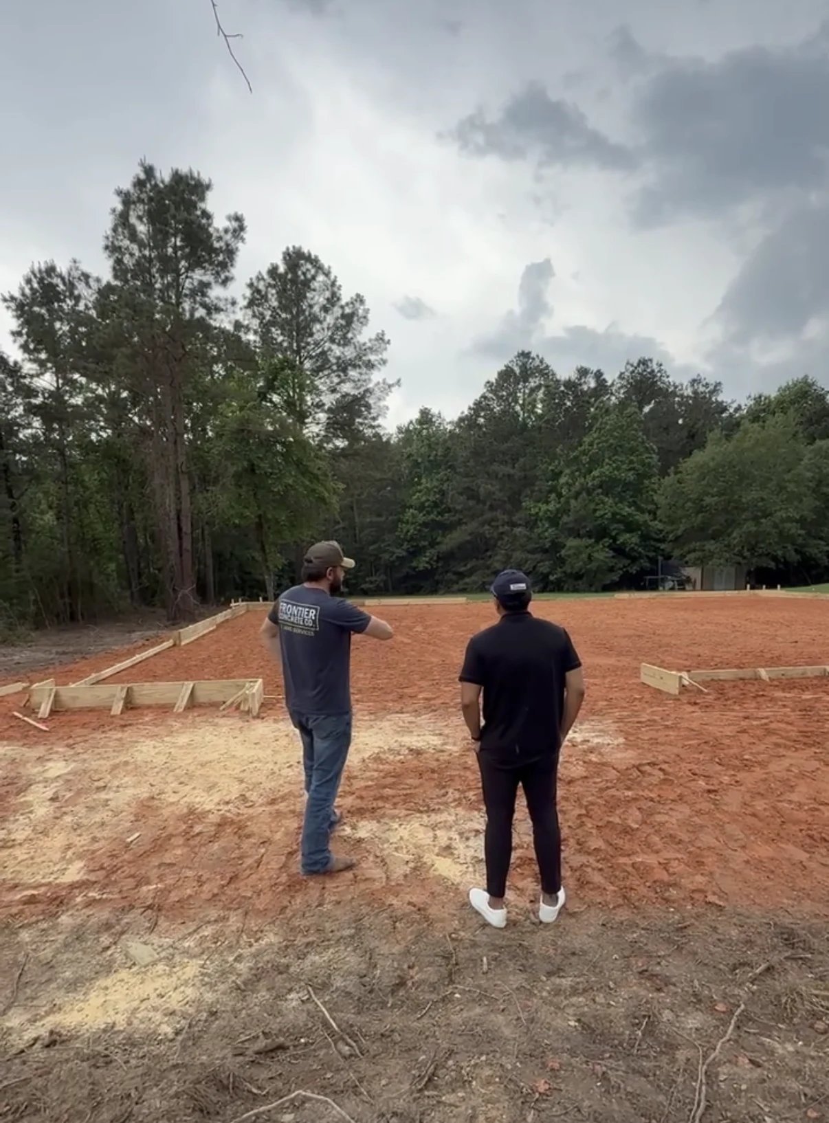 Dustin and a colleague reviewing a prepared building site
