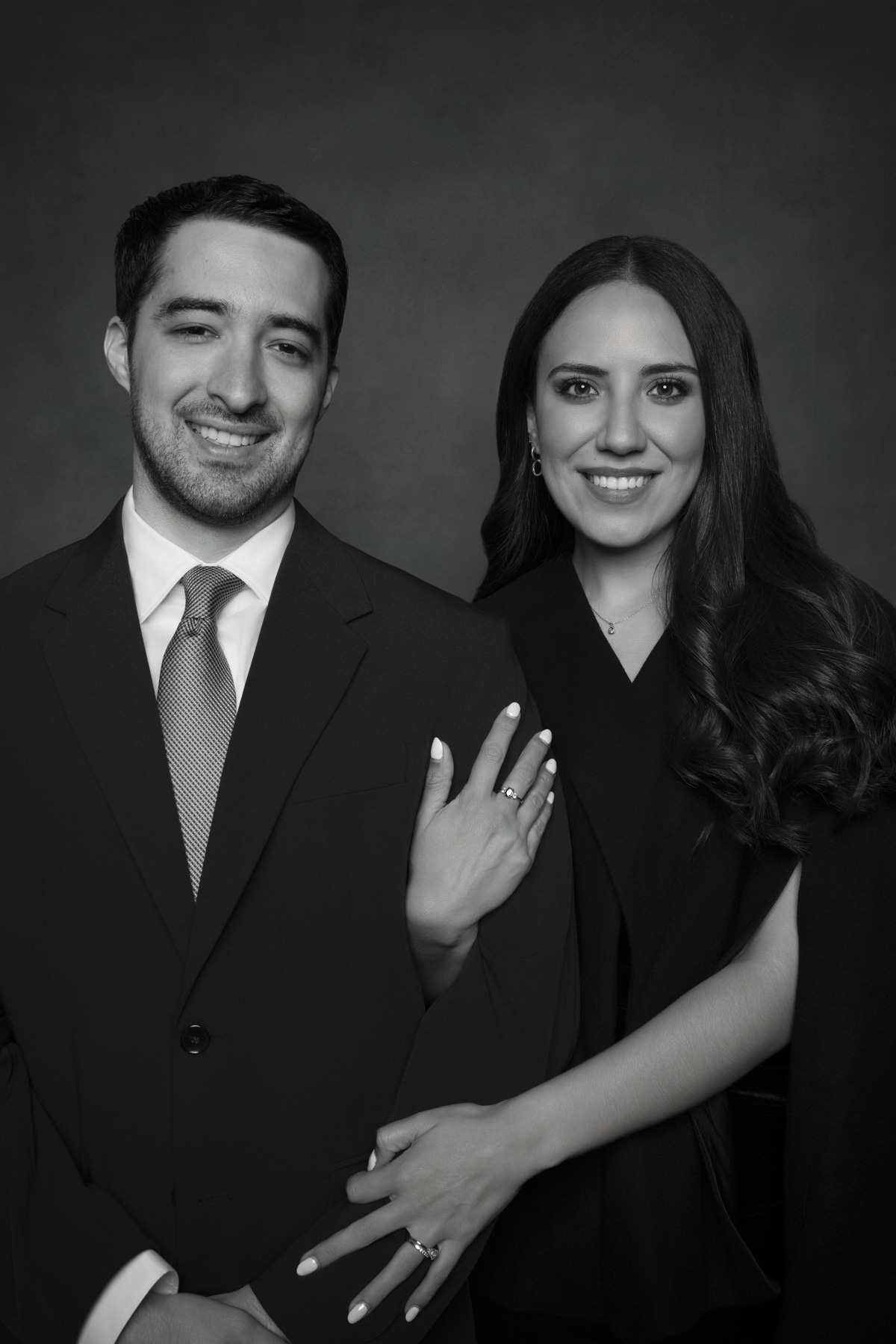 Fine art black and white portrait of wedding guests photographed in a professional studio during a luxury wedding reception.