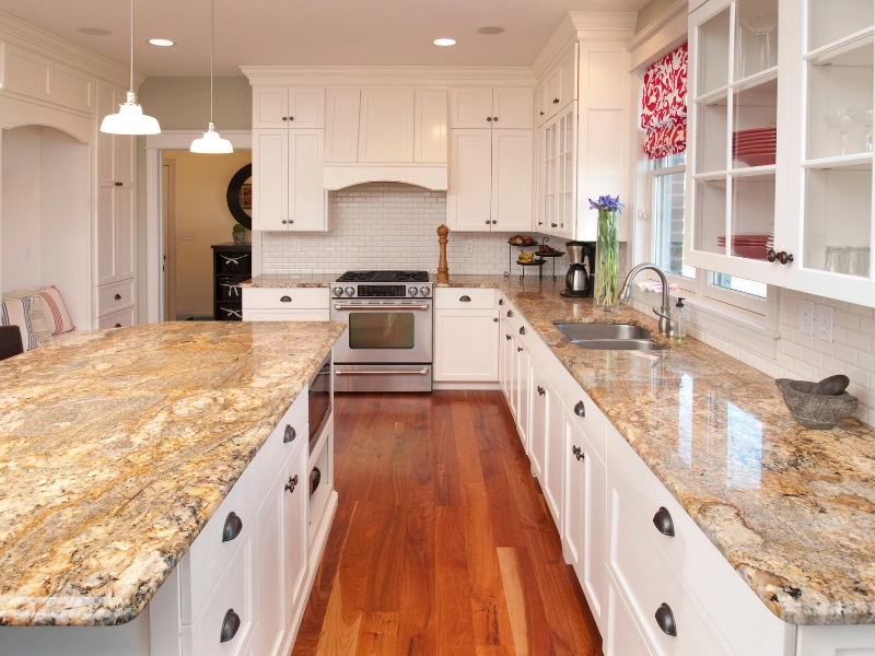 Modern white kitchen with custom cabinets, large island, and granite countertops