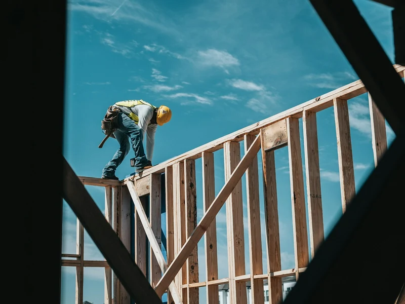 Carpenter framing the wall of a new home addition on a Rockingham County, NH house Carpenter framing the wall of a new home addition on a Rockingham County, NH house