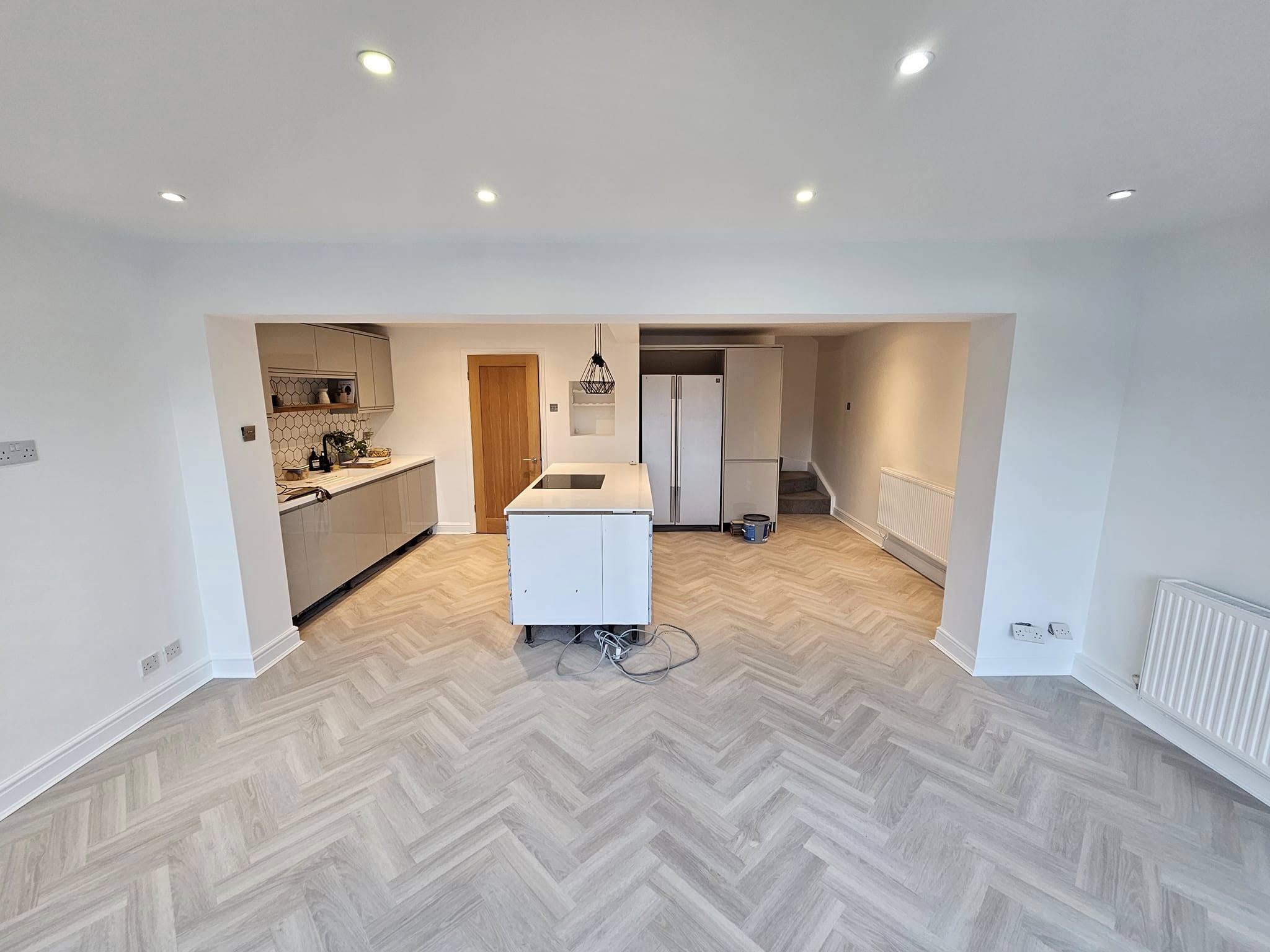 Freshly painted modern kitchen with grey cabinets and feature wall in Bettws home