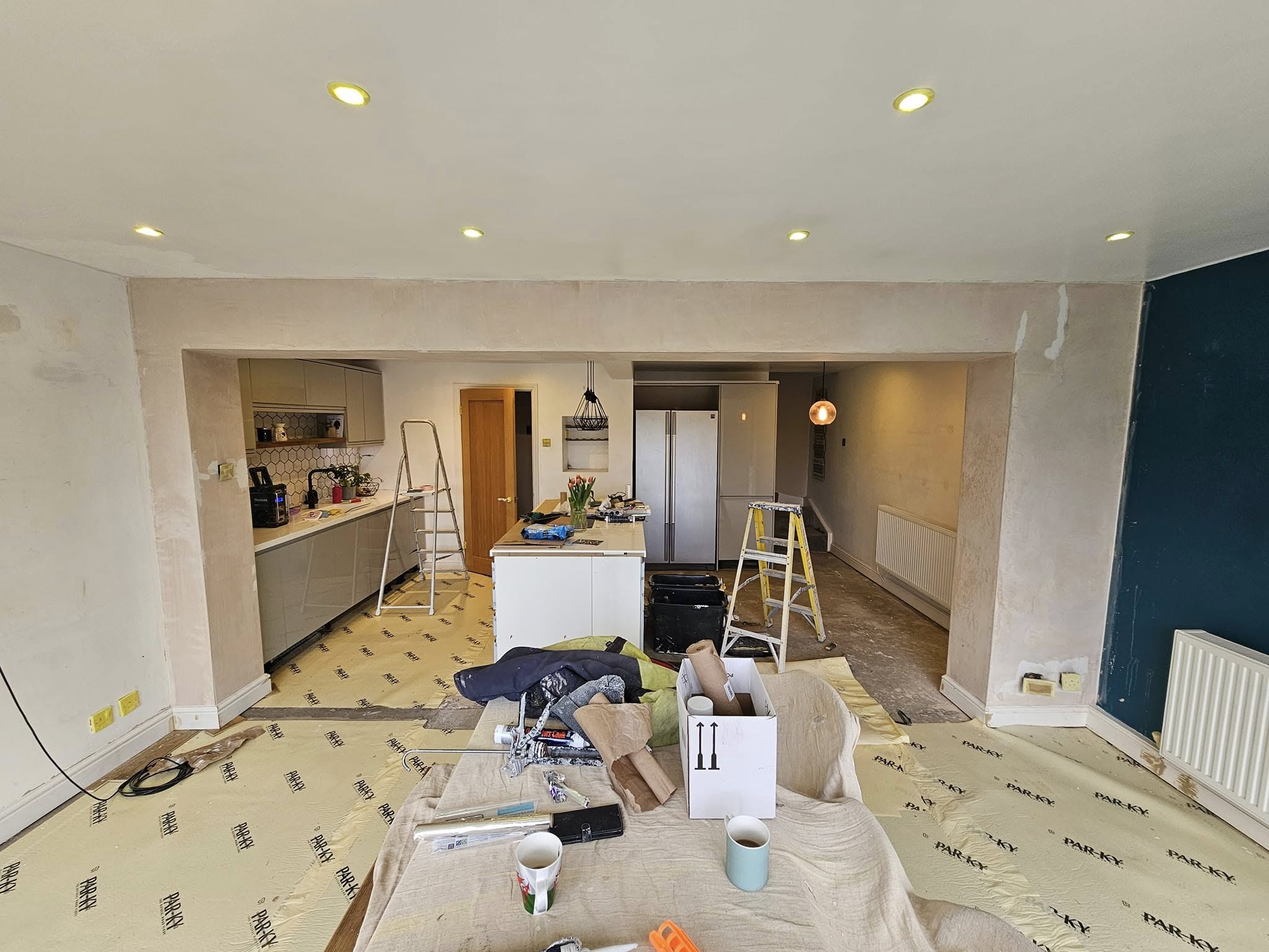During of Freshly painted modern kitchen with grey cabinets and feature wall in Bettws home