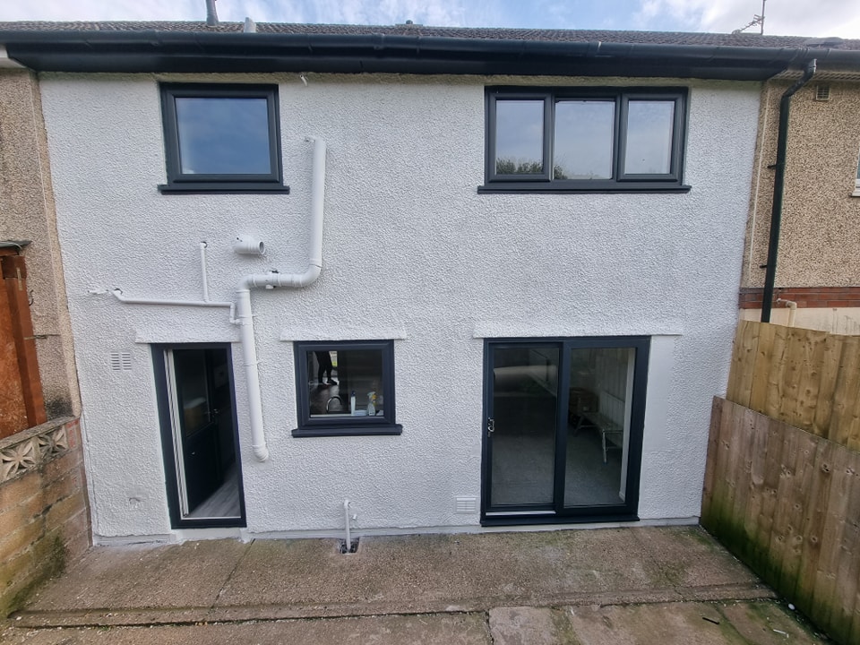 Exterior house painting completed on terraced house in Newport, Wales showing fresh white render