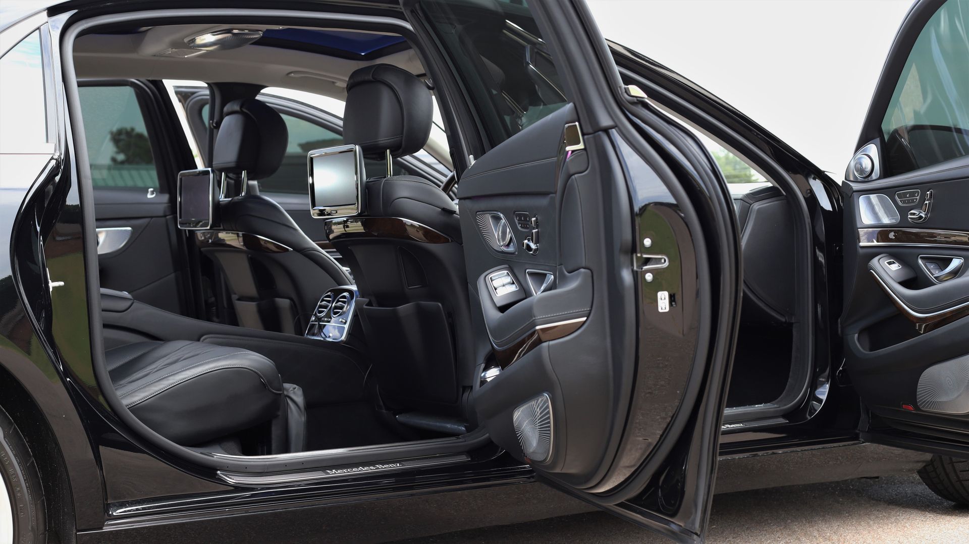 Luxury vehicle interior with leather seats and screens