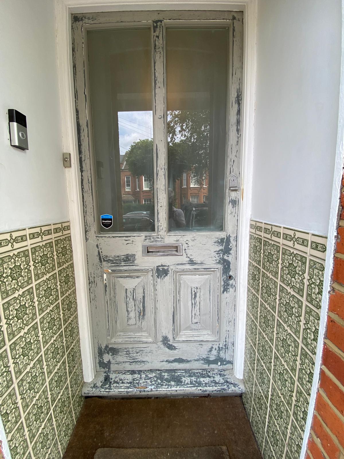 Victorian front door with severely peeling and flaking paint before restoration in Epsom, Surrey