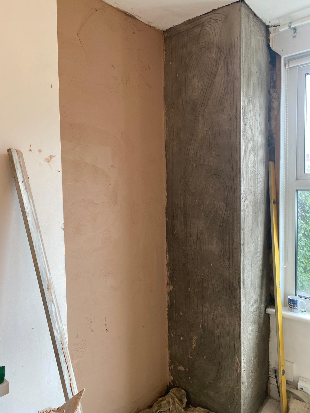 Internal wall plastering in Epsom showing brown coat on main wall and scratch coat on window reveal