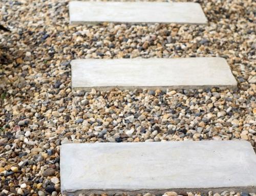 Concrete stepping stones in gravel completed by Metro Mowing Services and Maintenance LLC