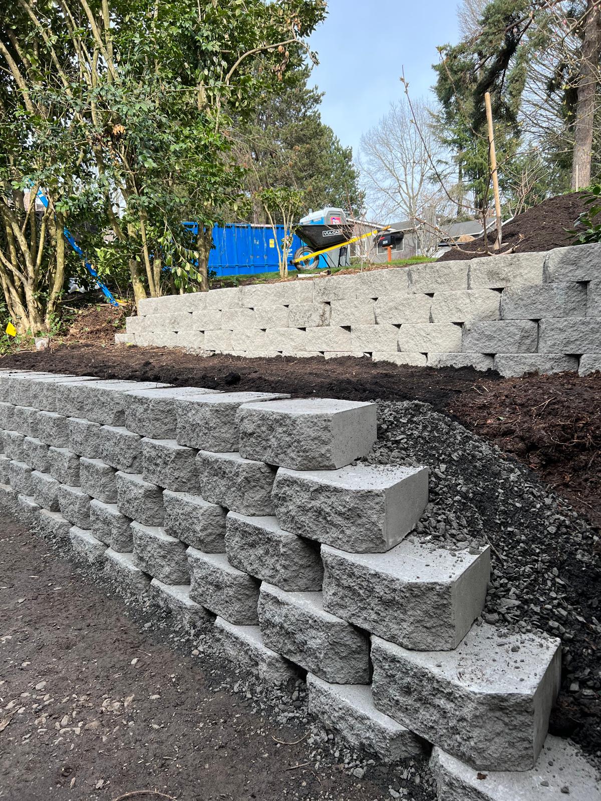Block retaining wall with steps completed by Metro Mowing Services and Maintenance LLC