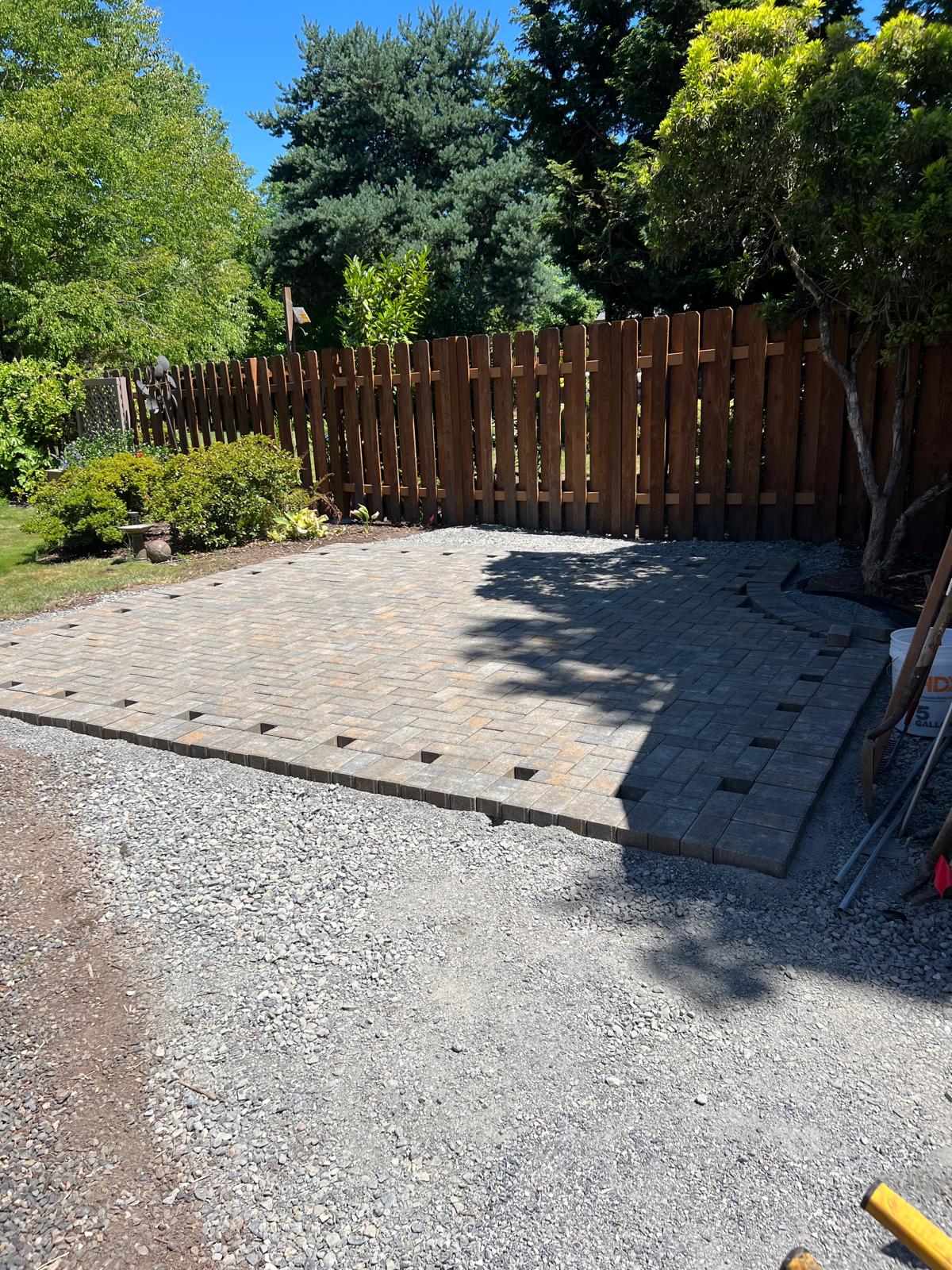 Paver patio with gravel border completed by Metro Mowing Services and Maintenance LLC